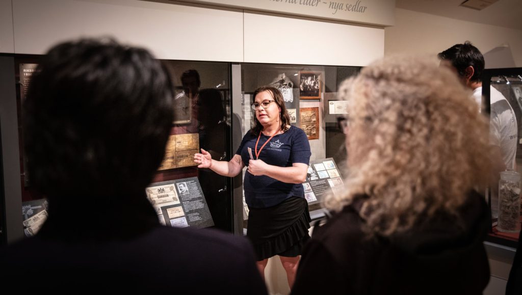 Visitors listening to a presentation at the Museum. Photo: https://tumbabruksmuseum.se/